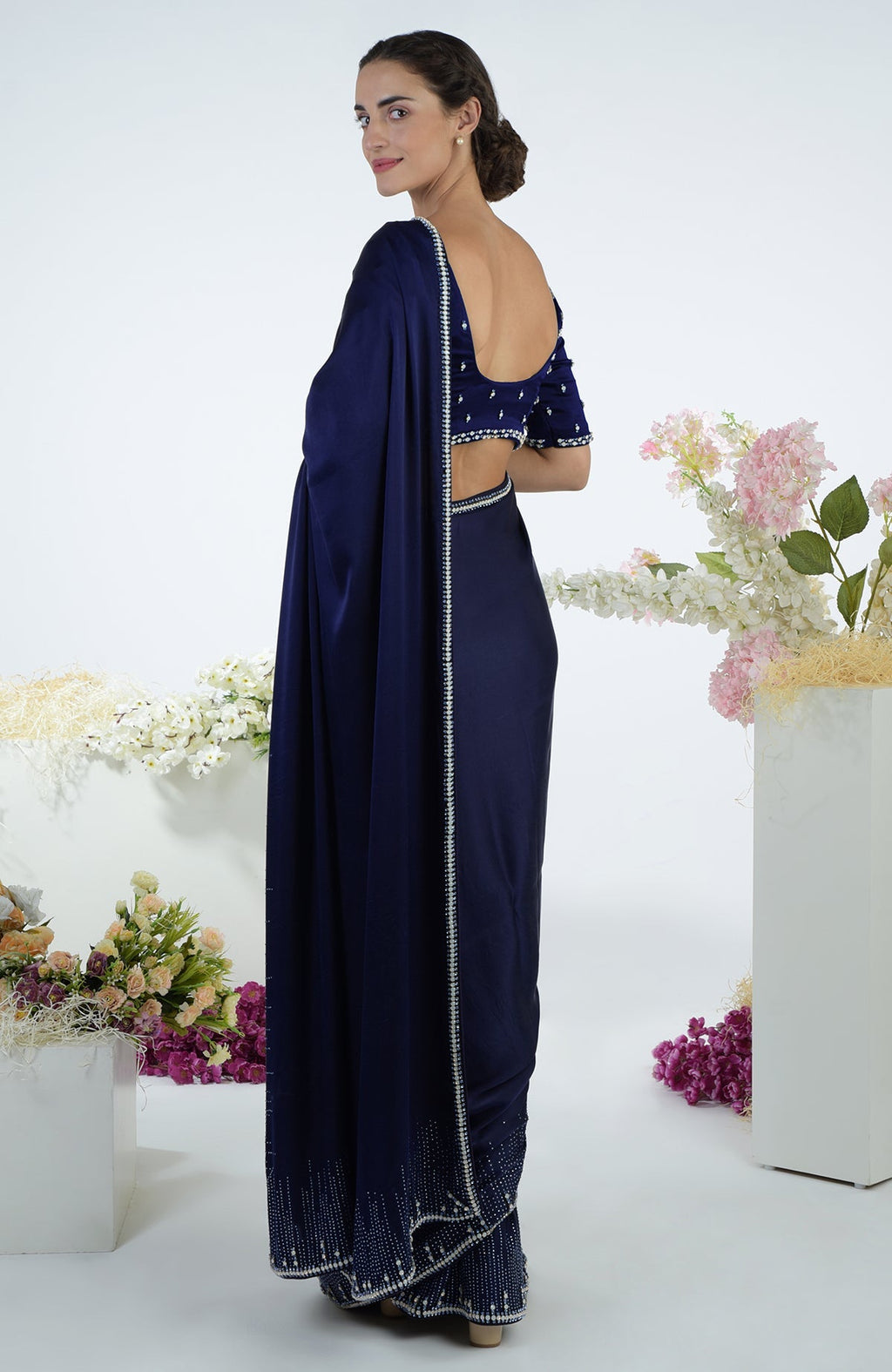 Woman in a midnight blue crystal hand-embroidered saree and blouse.