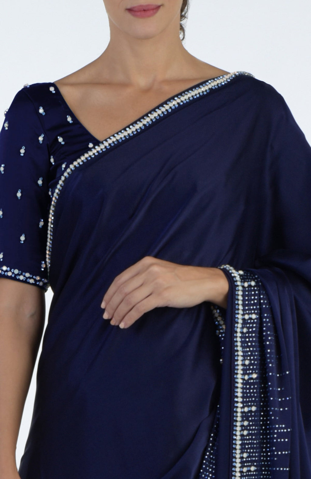 A woman models a midnight blue crystal hand-embroidered saree and blouse.
