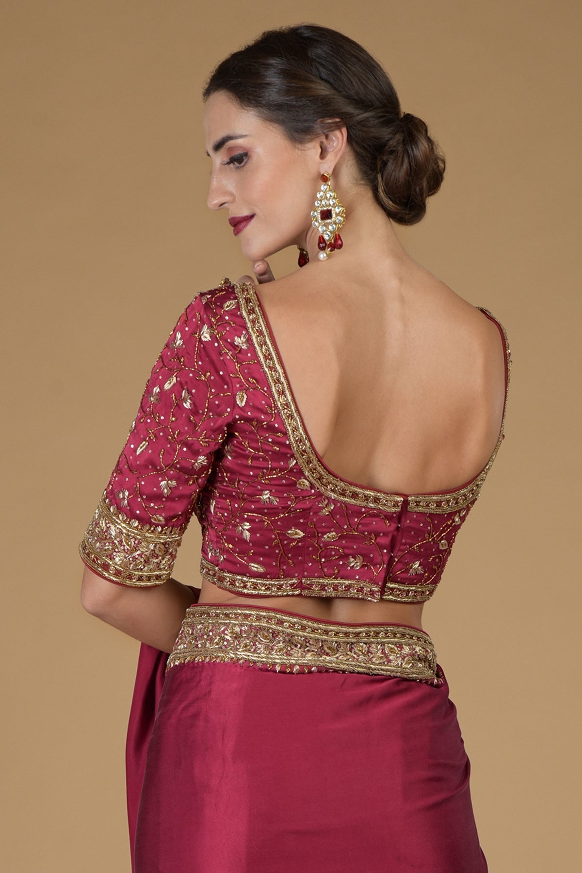 Maroon U Neck Hand Embroidered Zardozi Blouse with a deep back and elbow-length sleeves.