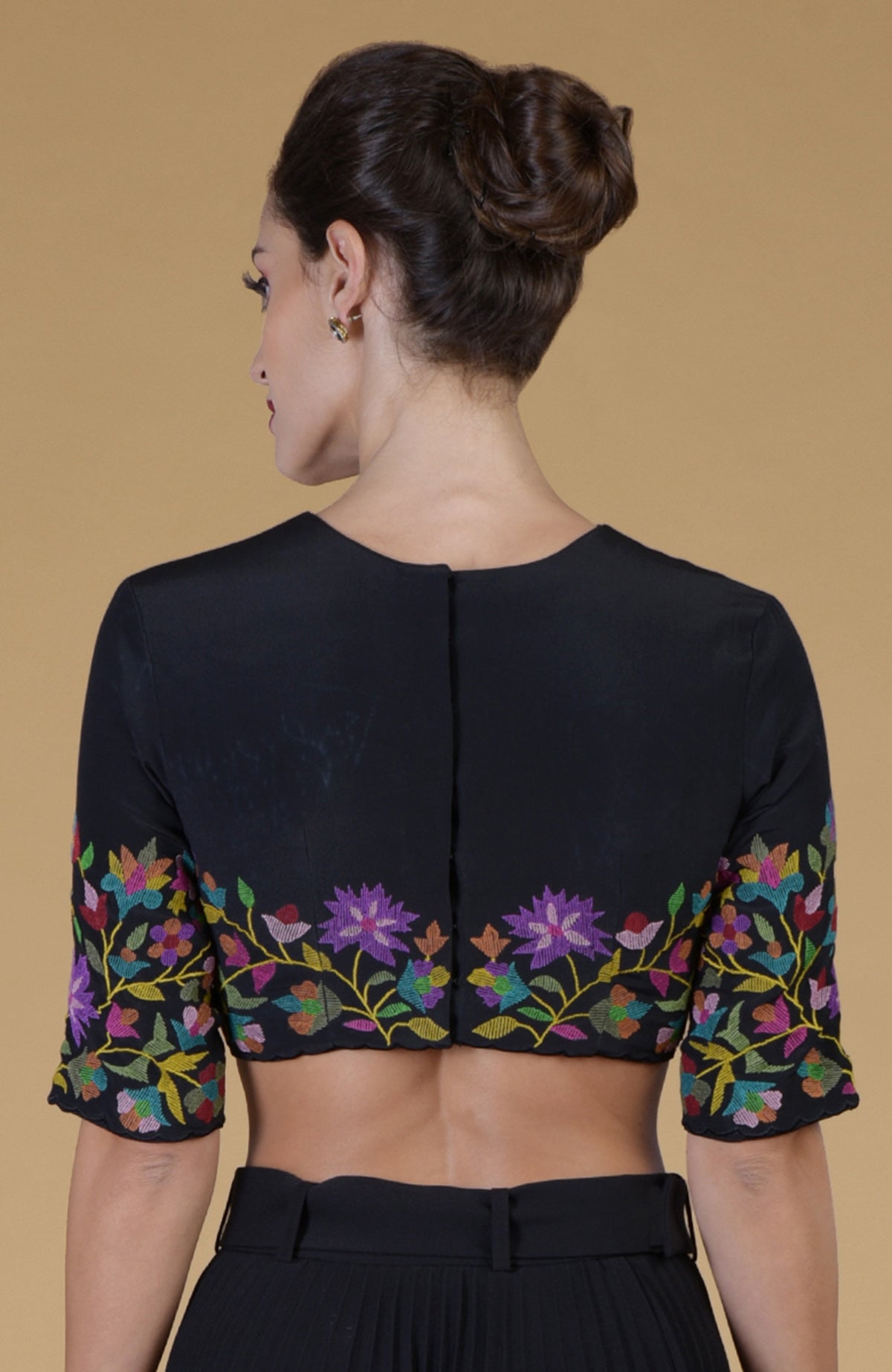 Black Kani Art embroidered jewel neck blouse with colorful floral patterns.