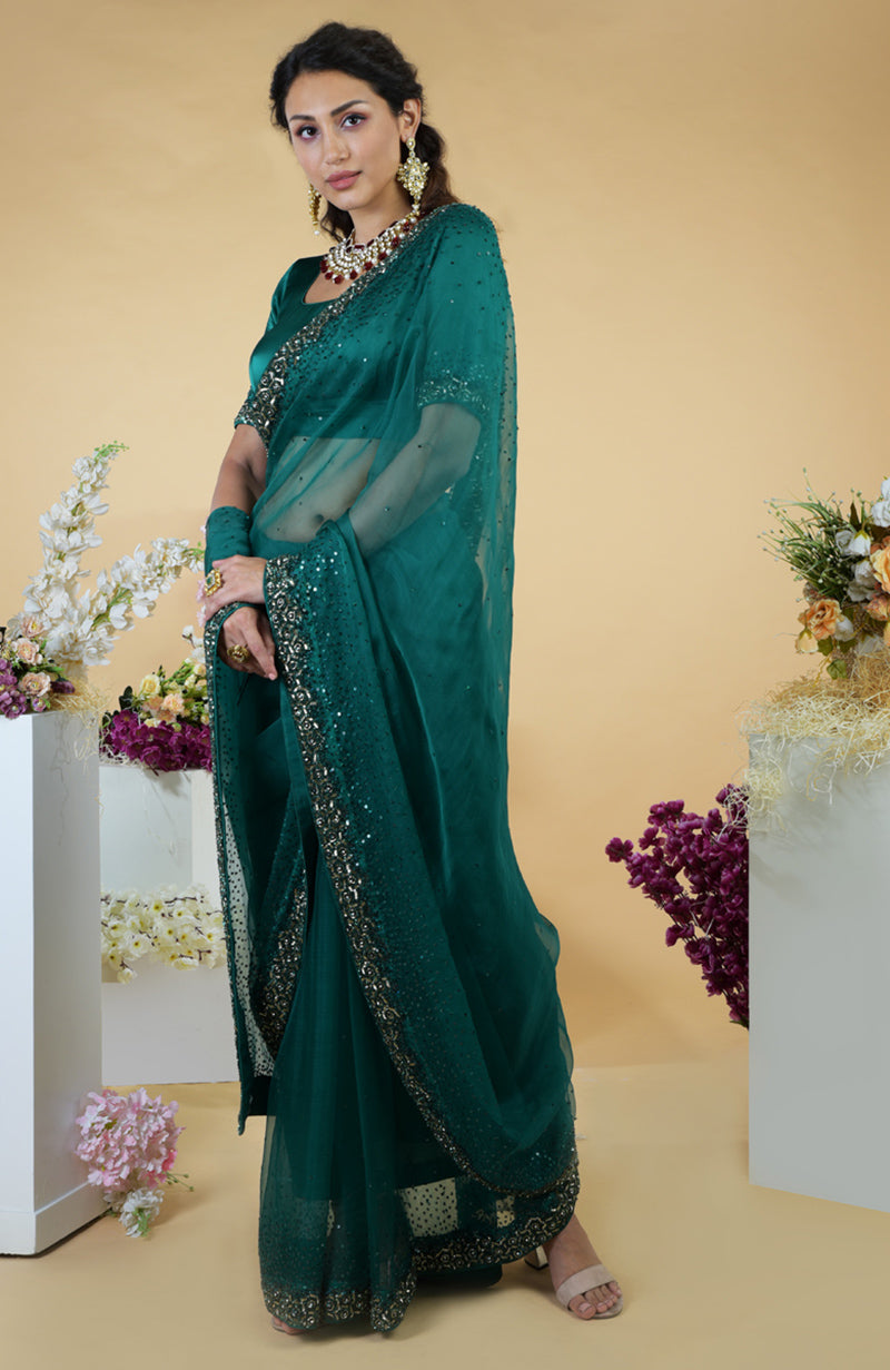 Emerald green organza saree with beads and sequin hand embroidery.