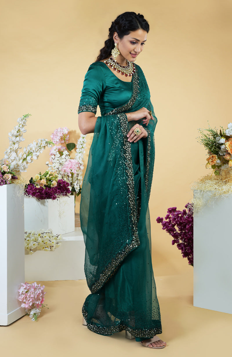Emerald green organza saree with bead and sequin embroidery.