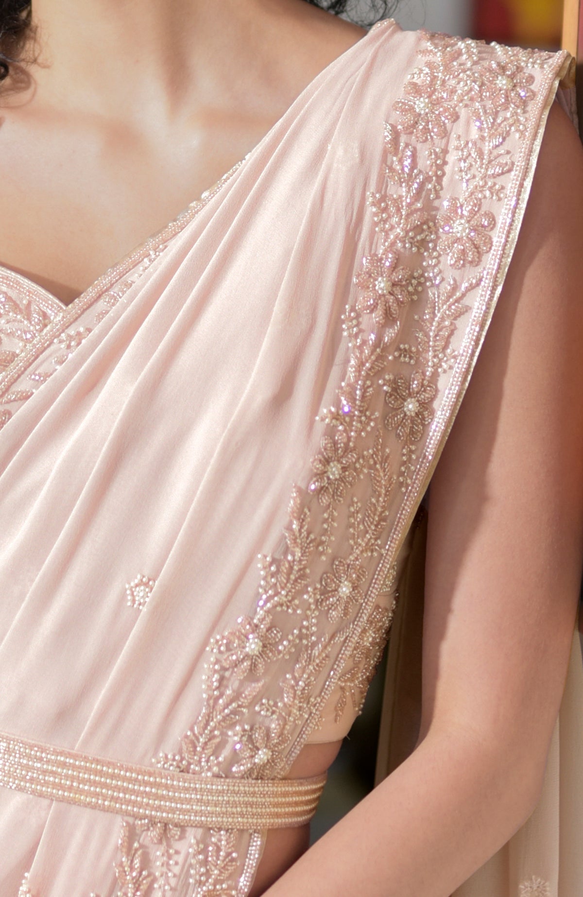 Nude pink saree with hand-embroidered pearl and bead floral designs and a sweetheart blouse neckline
