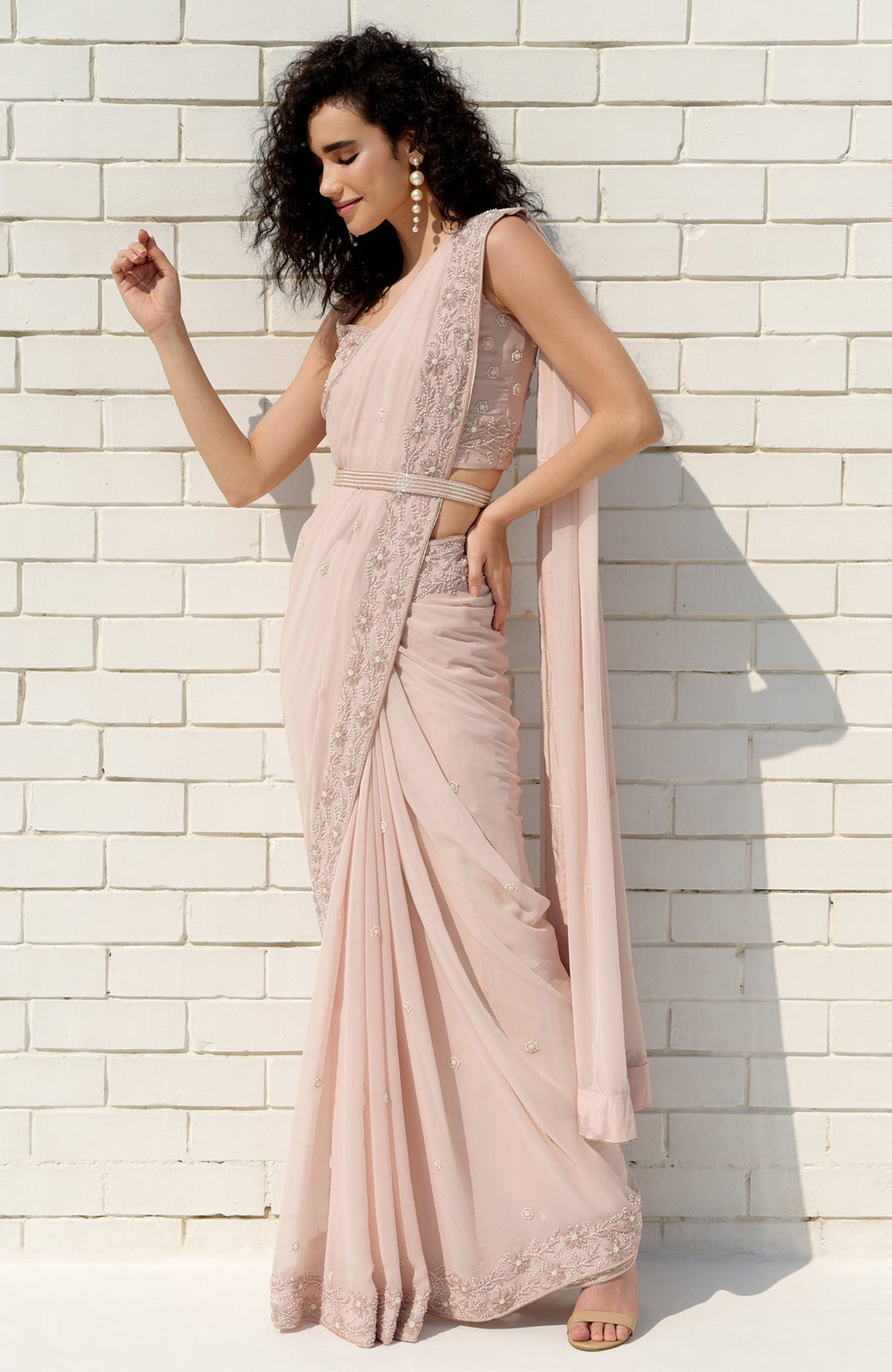 Nude pink saree with hand-embroidered pearl and bead floral designs and matching blouse.