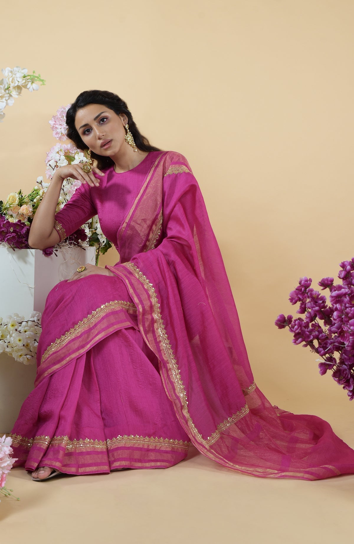 Raspberry linen saree with gold zardozi hand embroidery.