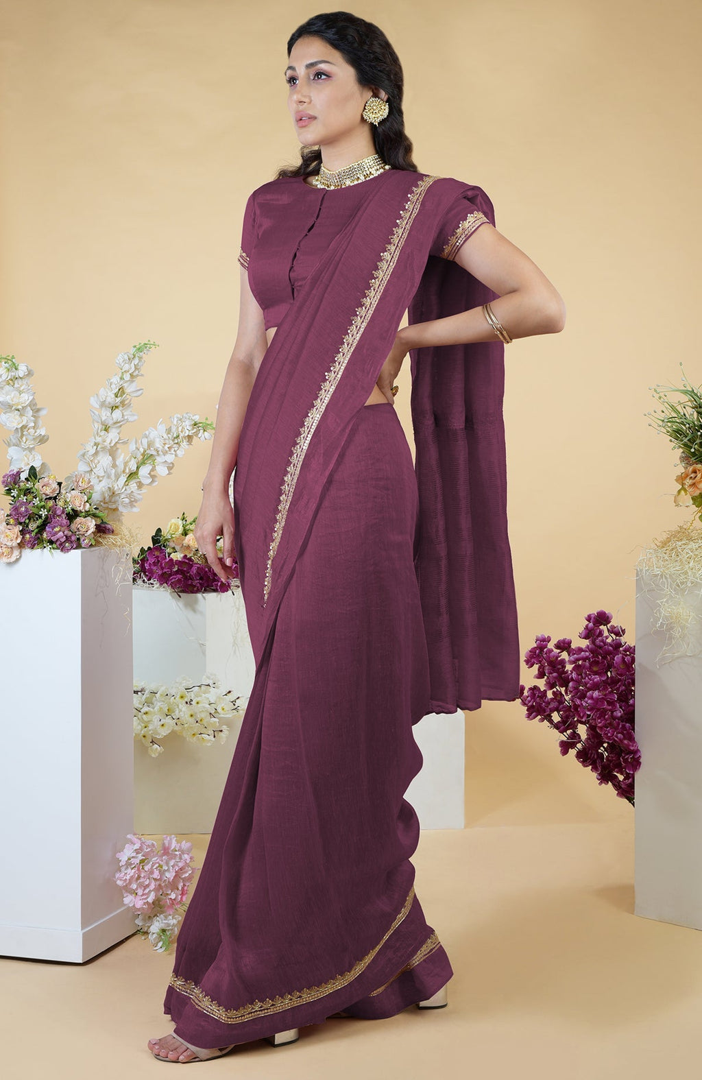 Burgundy purple linen saree with hand-embroidered gold zardozi work and matching blouse.