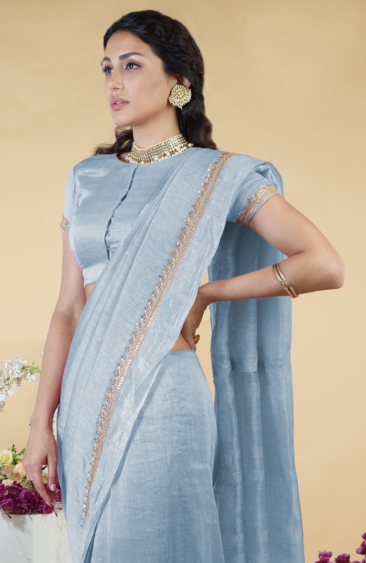 Dusty blue linen saree with hand-embroidered gold zardozi border and matching blouse