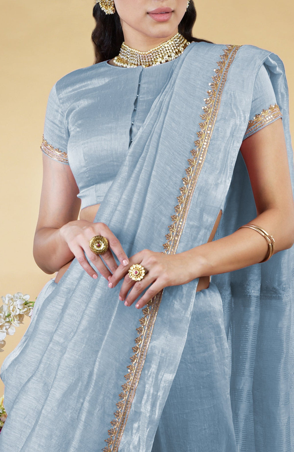 Dusty blue linen saree with gold hand-embroidered zardozi work and matching blouse.