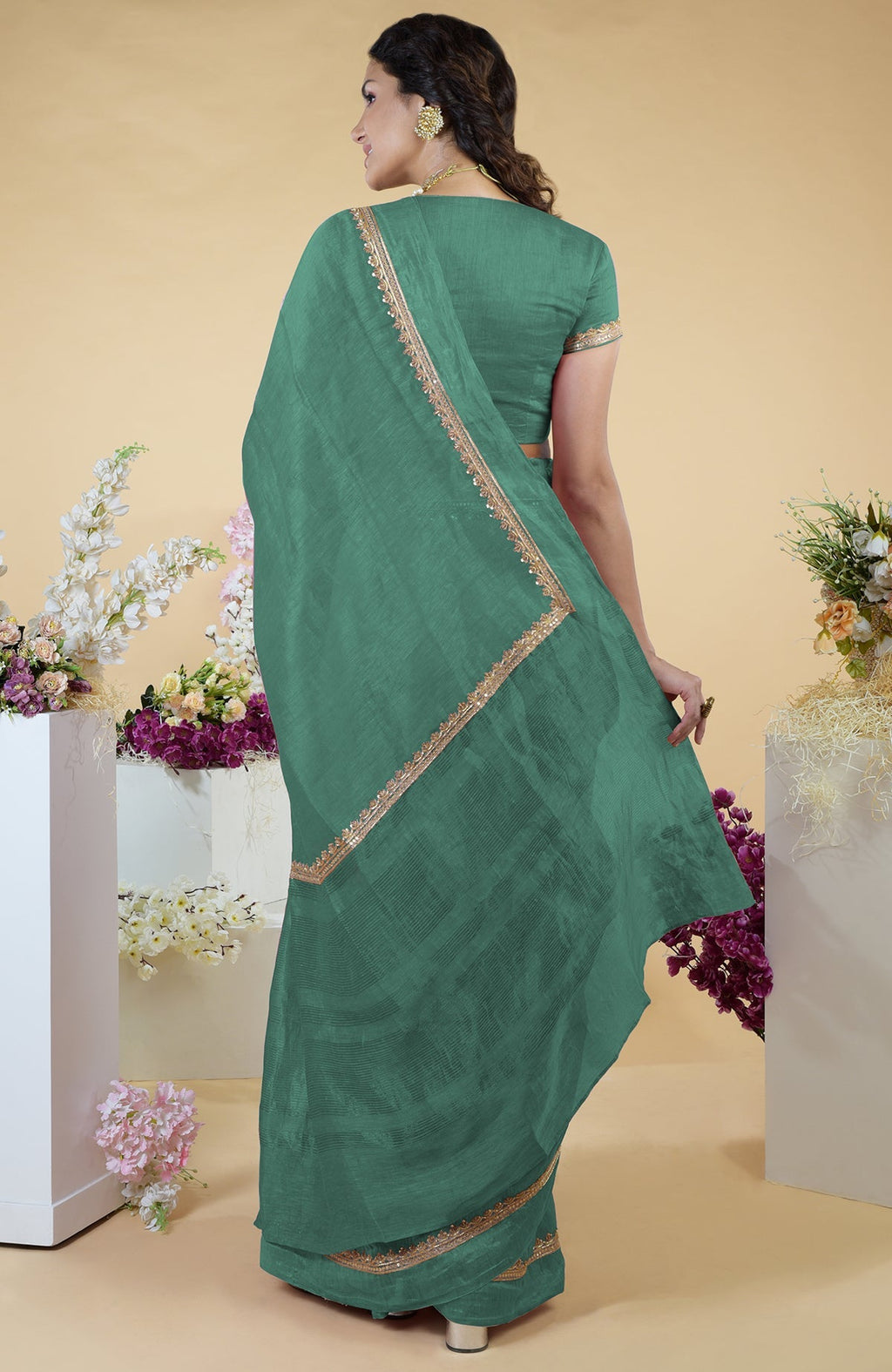 Linen saree with hand-embroidered gold zardozi work and matching blouse with round neck.