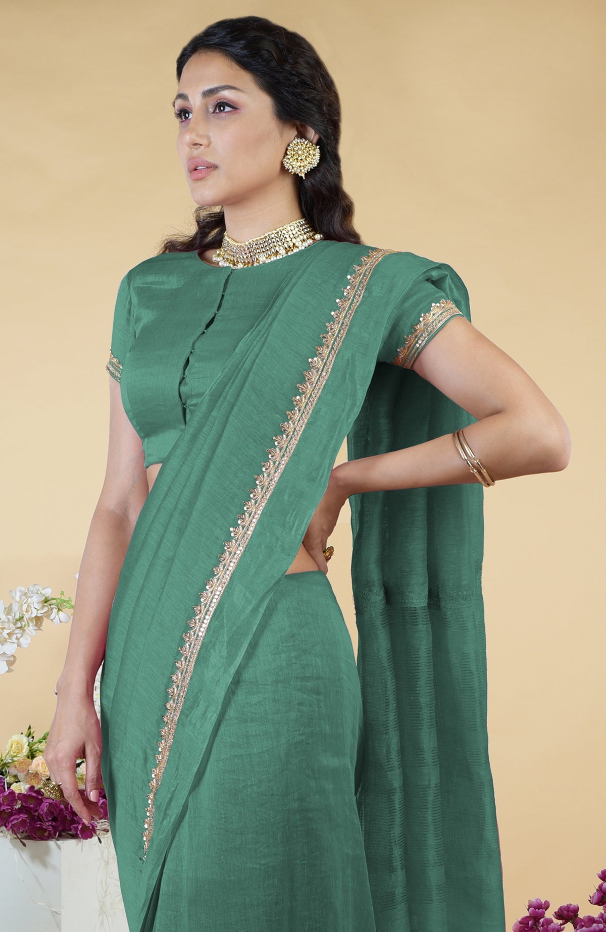 Kale linen saree with hand-embroidered gold zardozi work and matching blouse with jewel neck.