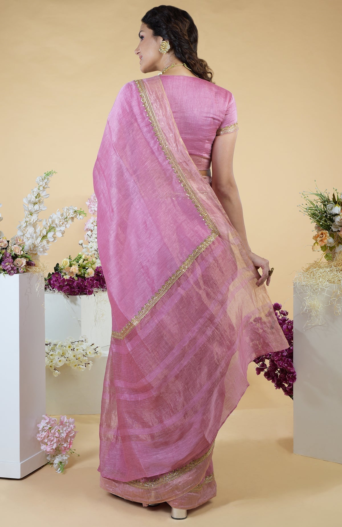 Withered rose hand-embroidered linen saree with gold zardozi work.