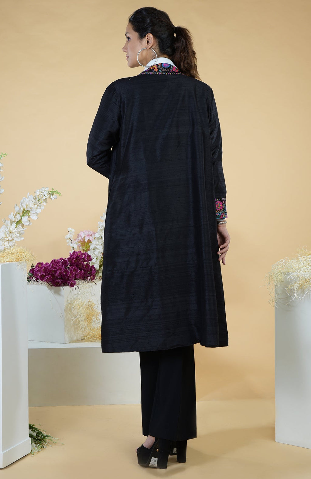 Black kimono jacket with colorful floral hand embroidery on the collar and sleeves.
