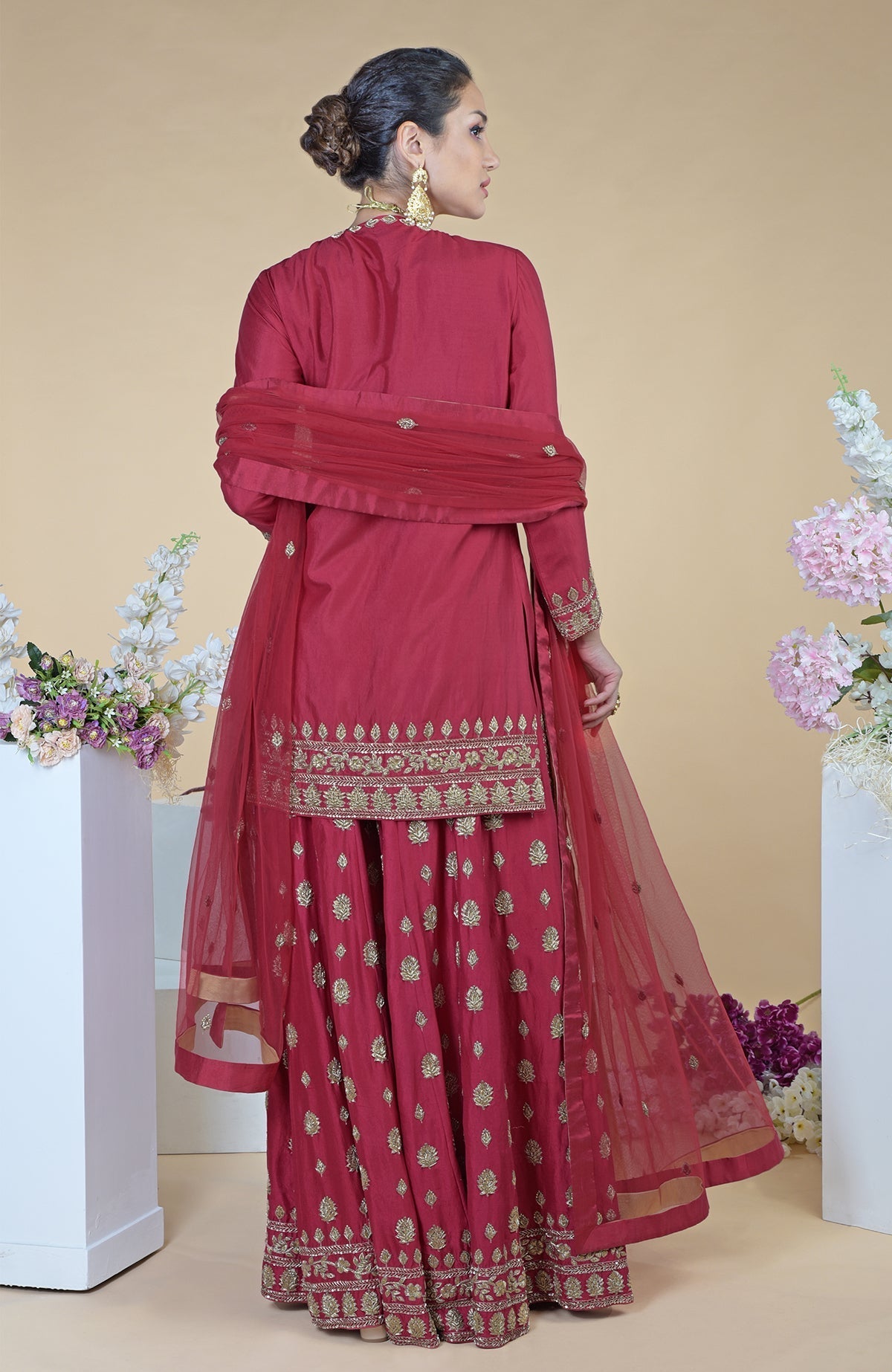 Crimson-gold zardozi dabka hand embroidered sharara set with a sheer tulle dupatta.