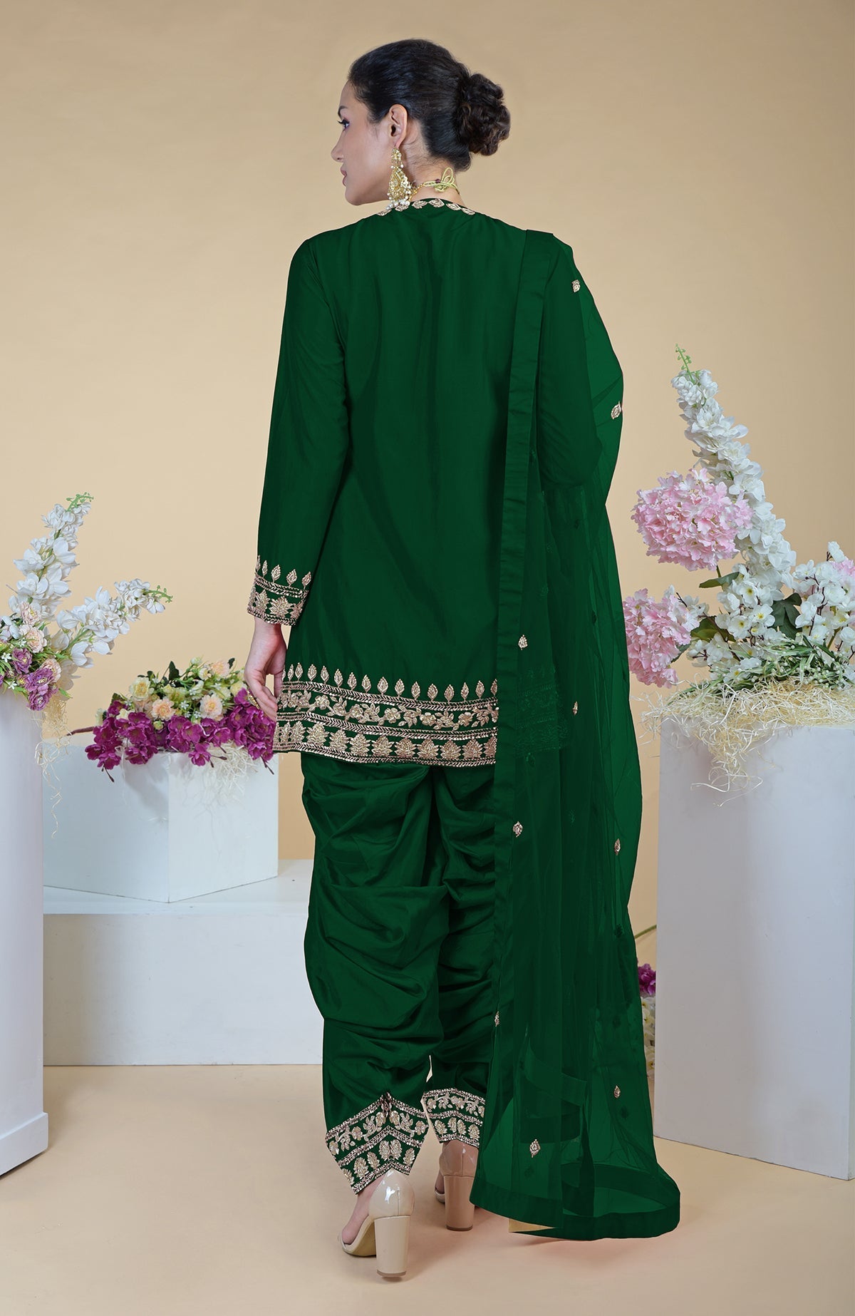 Emerald green salwar suit with gold zardozi embroidery and a sheer dupatta.