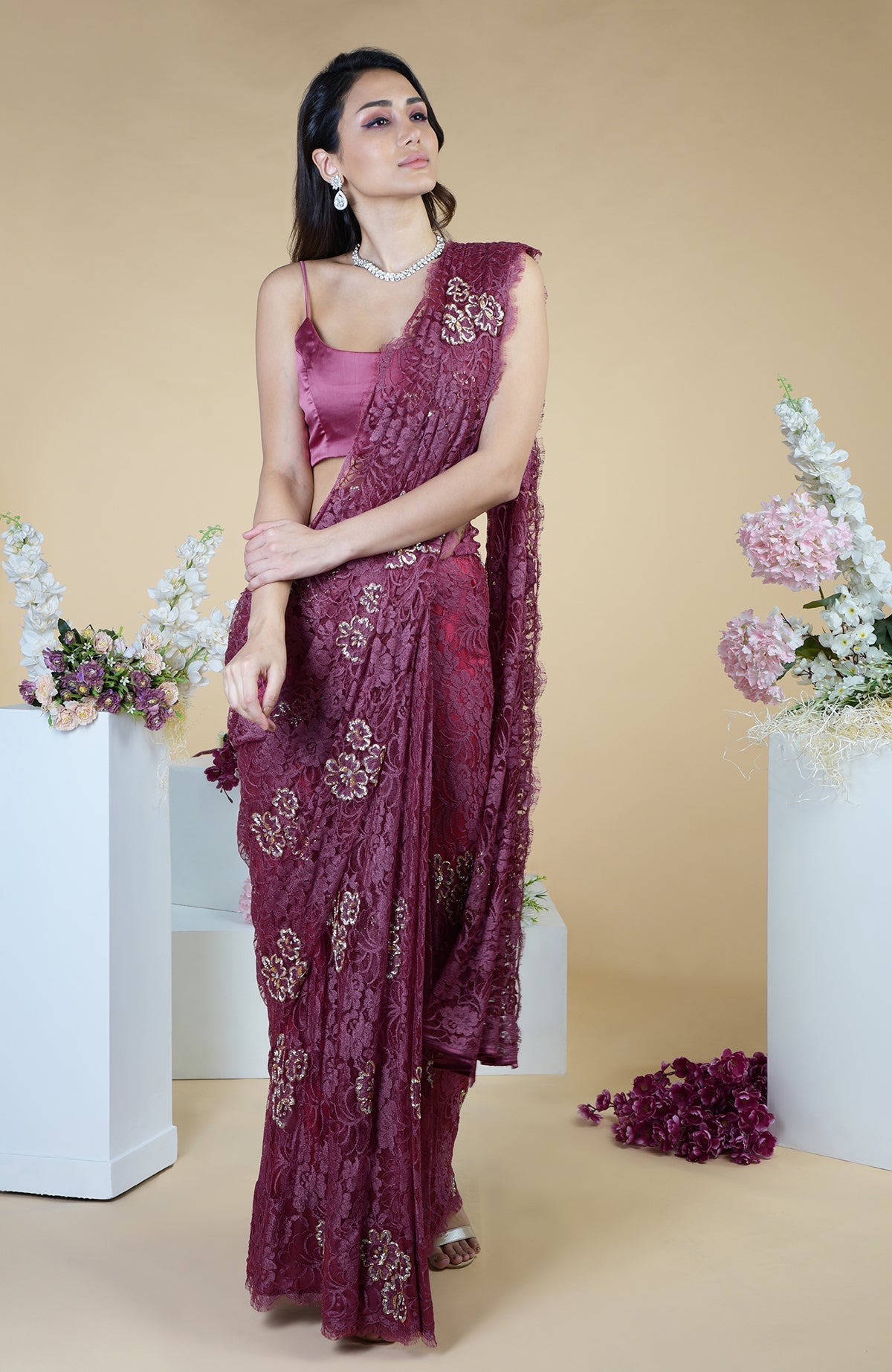 Wine French Chantilly saree with gold and silver hand embroidery, paired with a satin-silk blouse.
