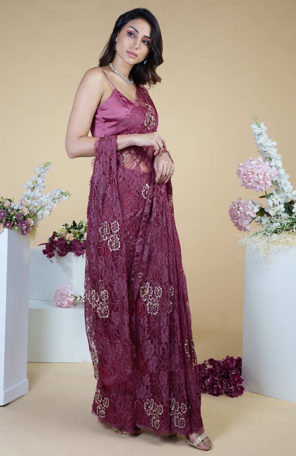 Wine French Chantilly hand-embroidered saree with a sleeveless satin-silk blouse.