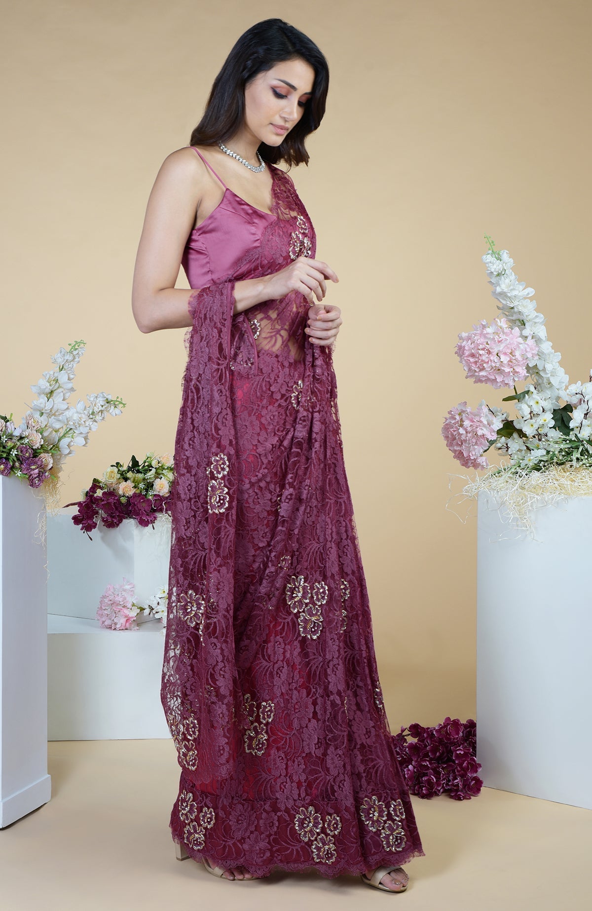 Wine French Chantilly hand-embroidered saree with a sleeveless blouse.