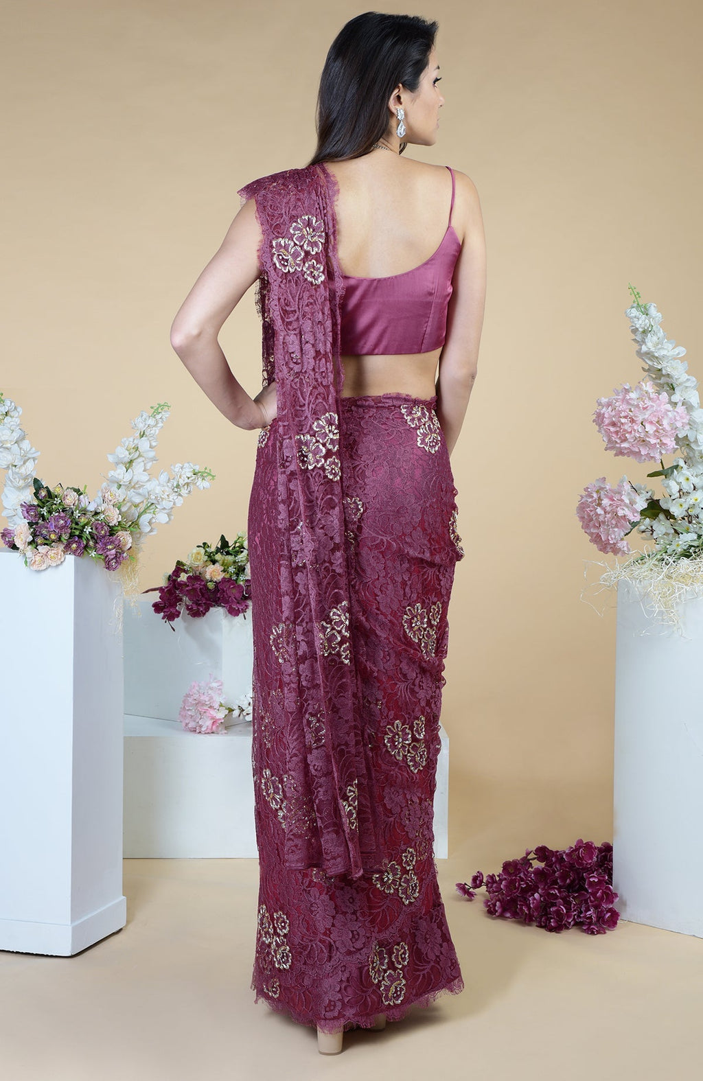 A woman from behind wears a wine French Chantilly hand-embroidered saree.