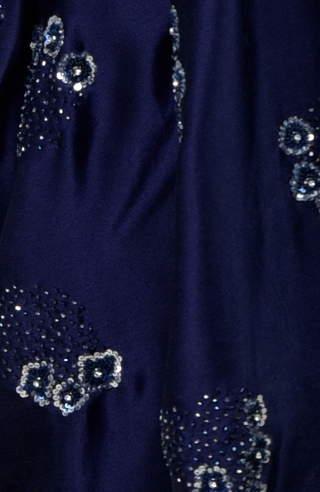 Midnight blue fabric with scattered silver and blue sequin and bead embroidery.