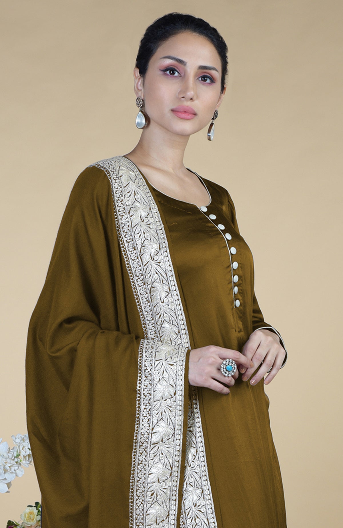 A woman models a burnt olive Kashmiri Tilla embroidered dupatta with a matching suit.