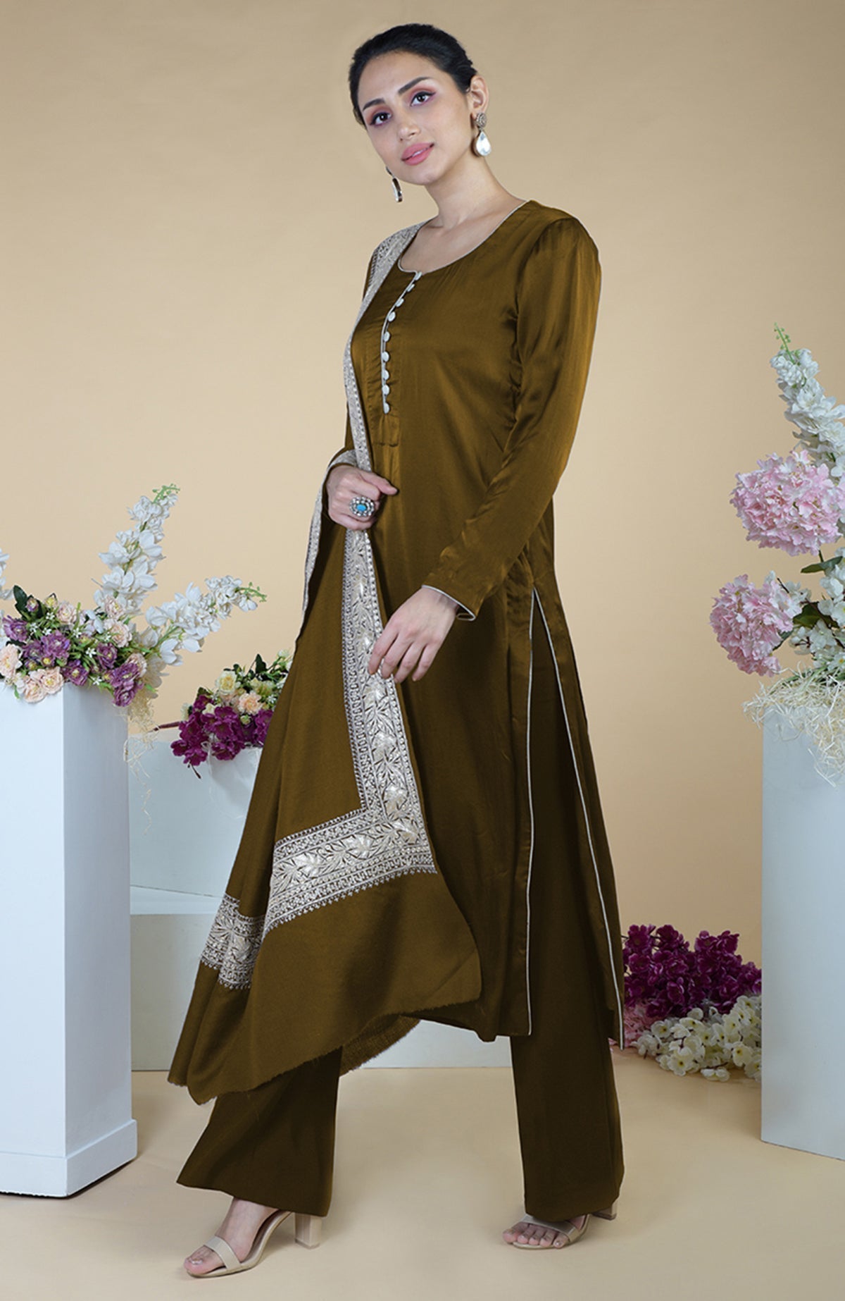 A woman models a burnt olive Kashmiri Tilla embroidered dupatta with a matching suit.