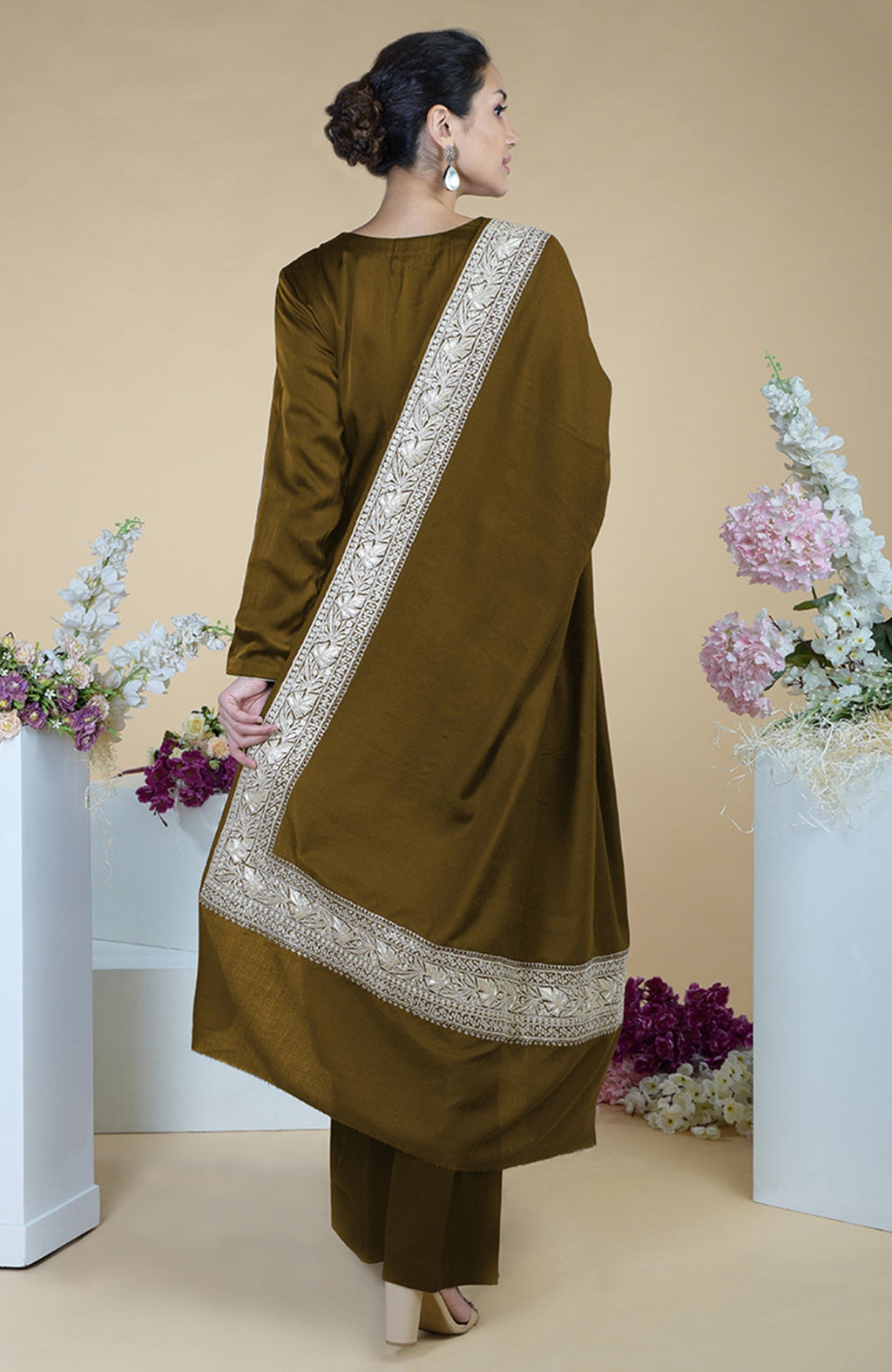 A woman models a burnt olive Kashmiri Tilla embroidered dupatta with a matching suit.
