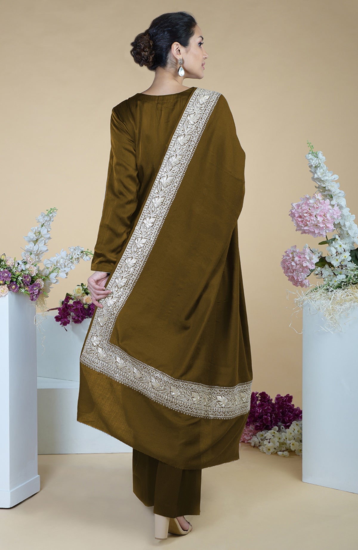 A woman models a burnt olive Kashmiri Tilla embroidered dupatta with a matching suit.
