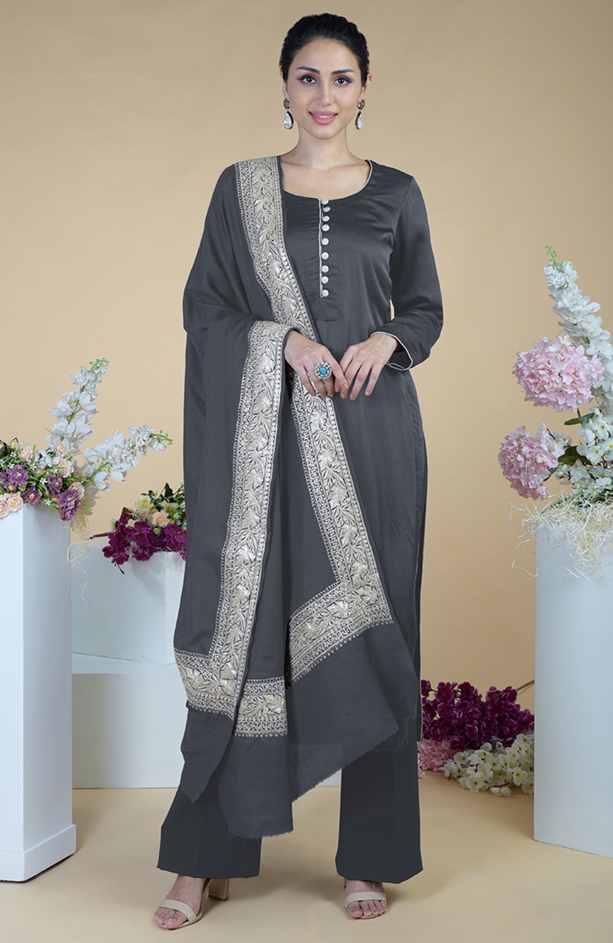 A woman models a teal Kashmiri Tilla embroidered pure silk dupatta suit.