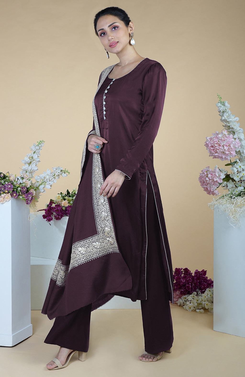 A woman models a royal purple silk suit with silver Tilla embroidered dupatta.