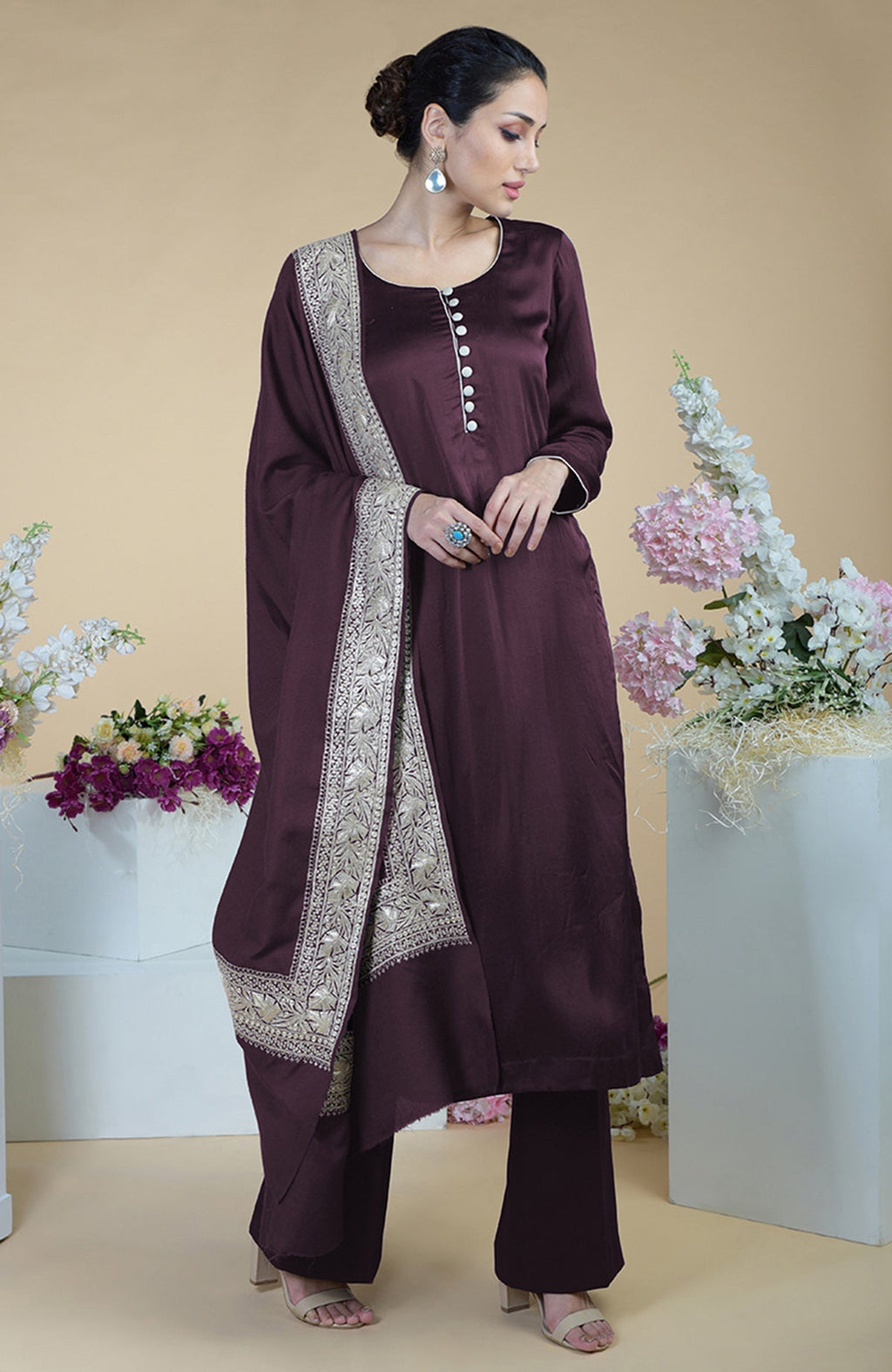 A woman models a royal purple silk suit with a Tilla embroidered dupatta.