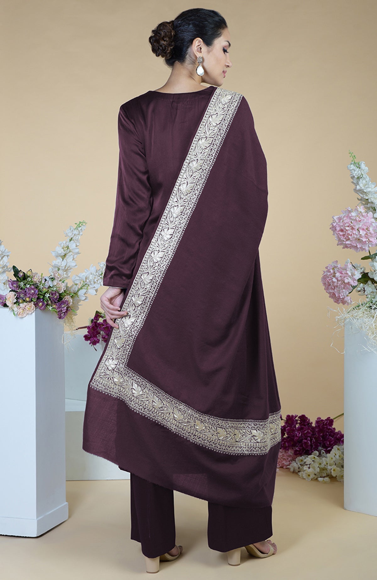 A woman models a royal purple Kashmiri Tilla embroidered silk dupatta with a suit.