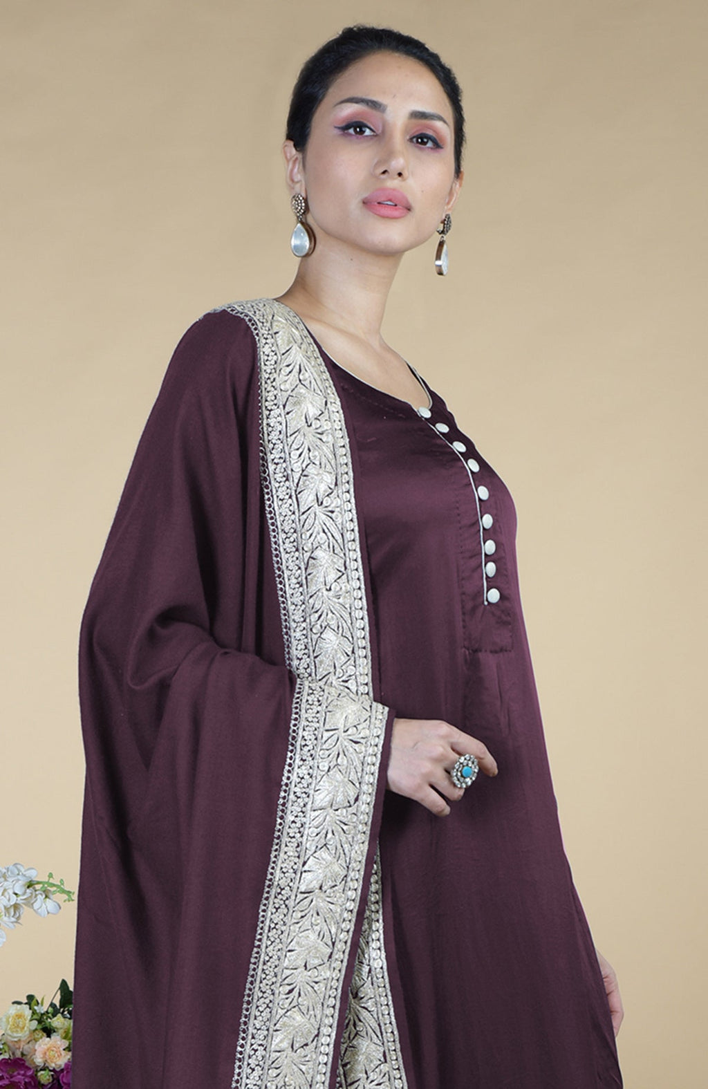 A woman models a royal purple Kashmiri Tilla embroidered silk dupatta with a suit.