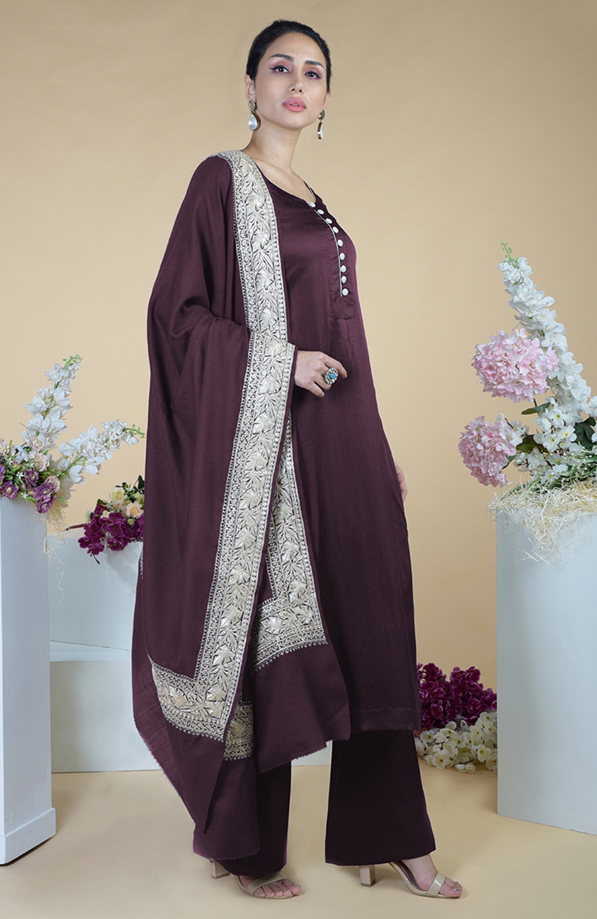 A woman models a royal purple Kashmiri Tilla embroidered silk suit with a dupatta.