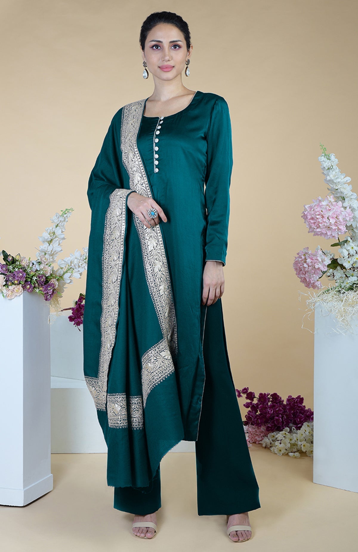 A woman models a grey Kashmiri Tilla embroidered silk dupatta with a matching suit.