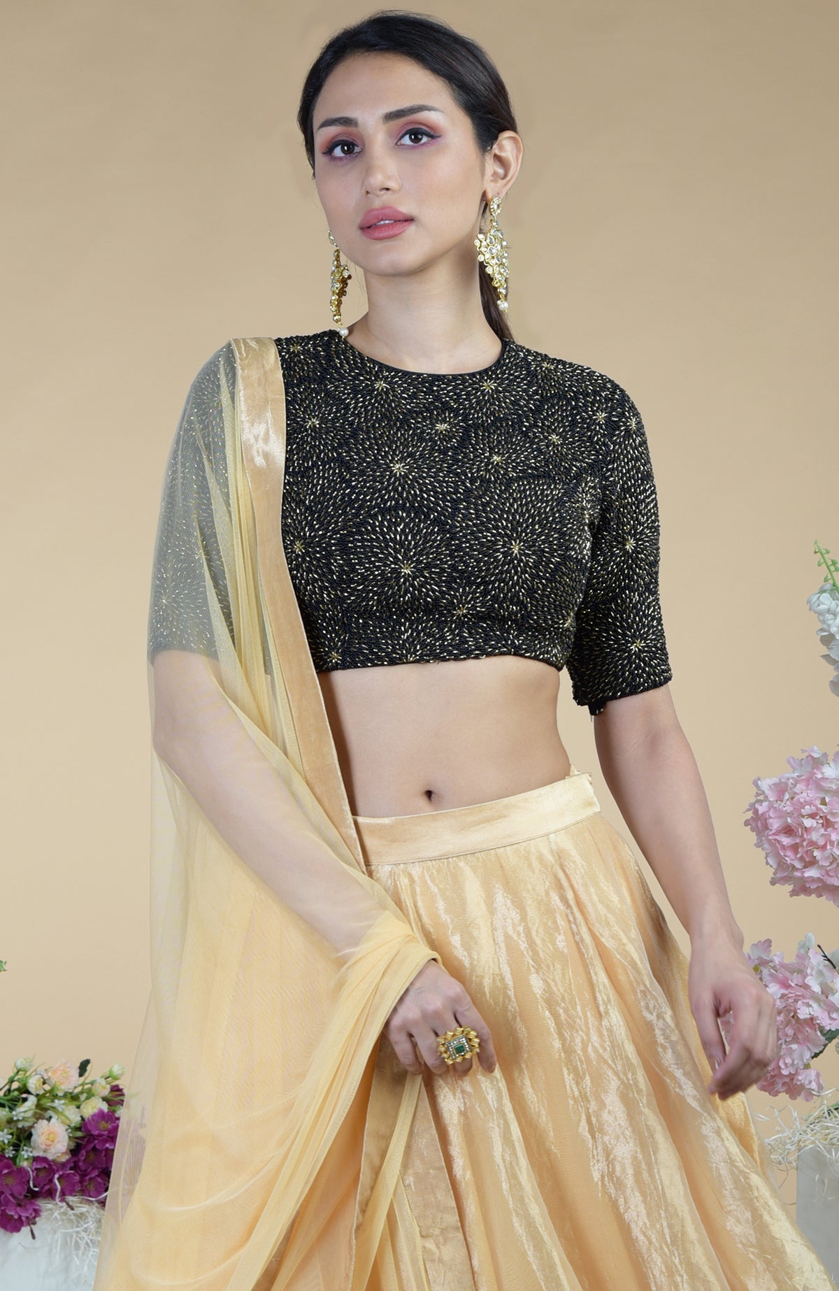 Black-gold hand embroidered blouse with a gold tissue skirt and matching dupatta.