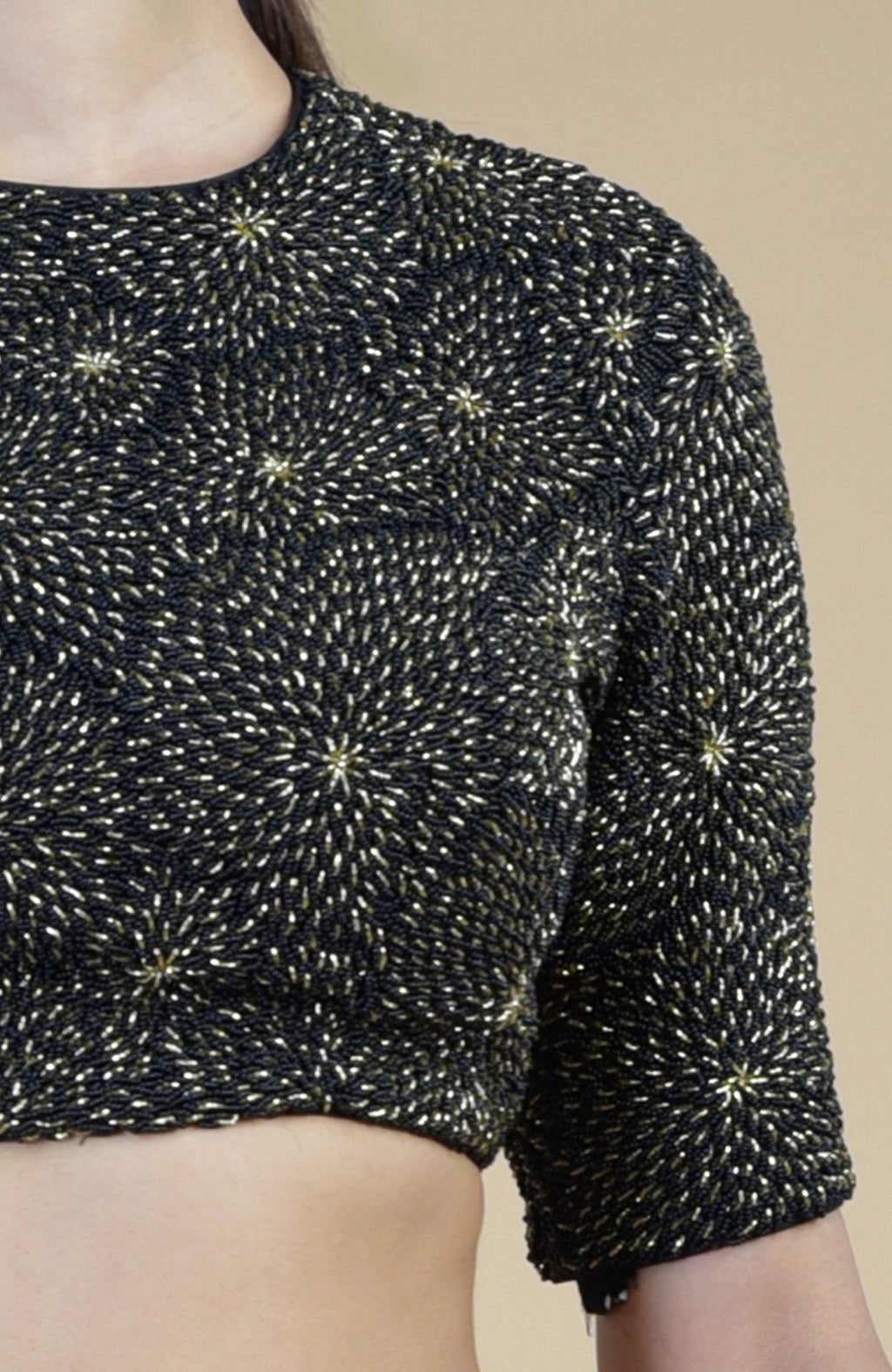 Black-gold hand-embroidered blouse with a jewel neck and elbow-length sleeves.