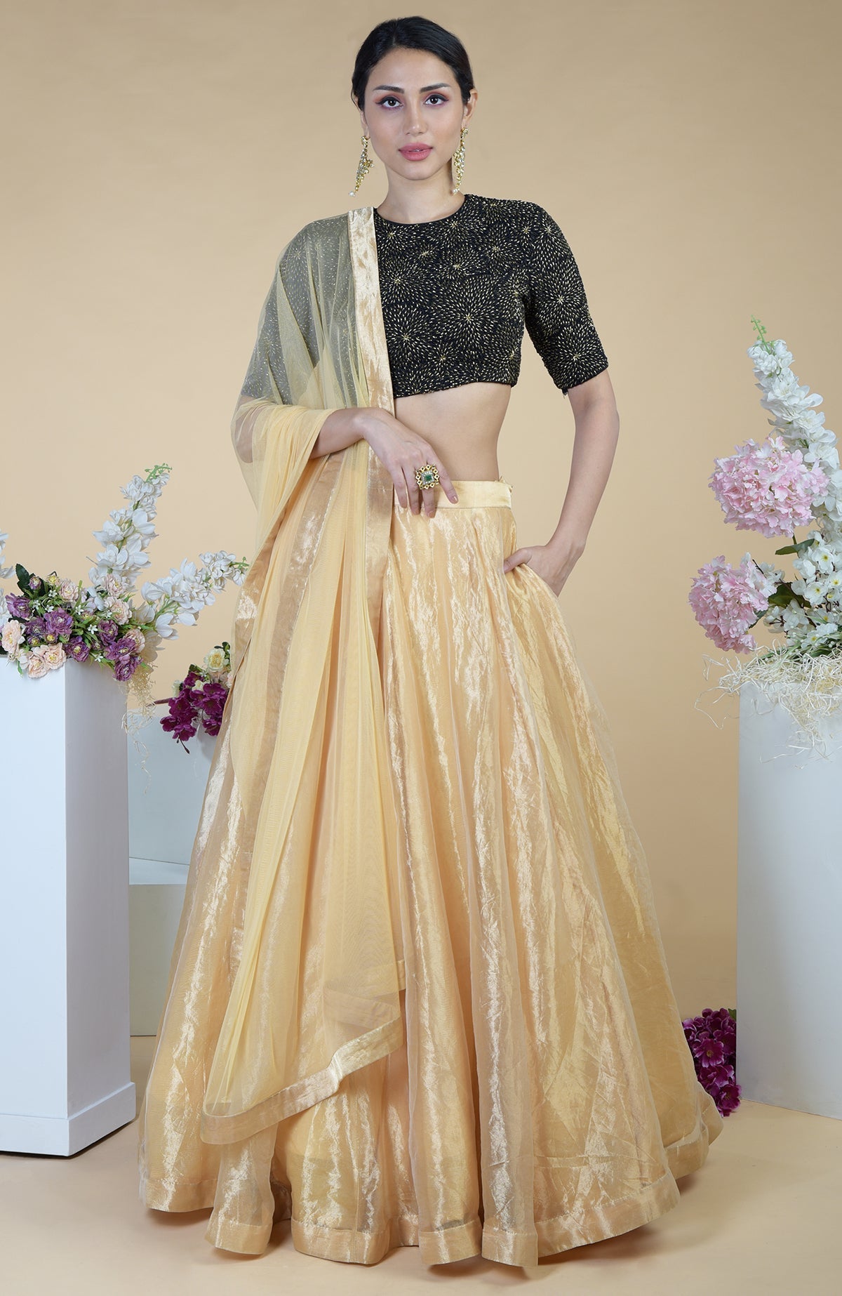 Black-gold hand-embroidered blouse with a gold tissue skirt and dupatta.