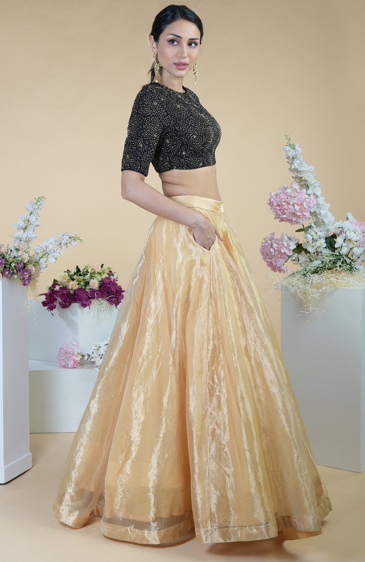 Black-gold hand-embroidered blouse with a gold tissue skirt.