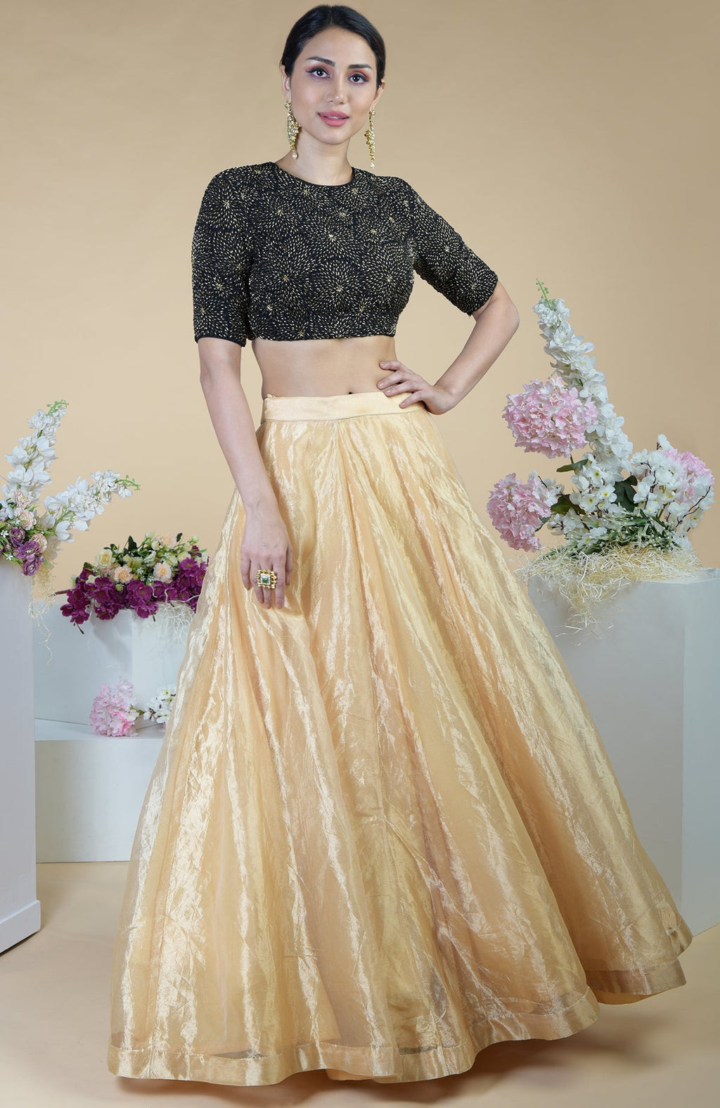 Black-gold hand-embroidered blouse with a gold tissue skirt.