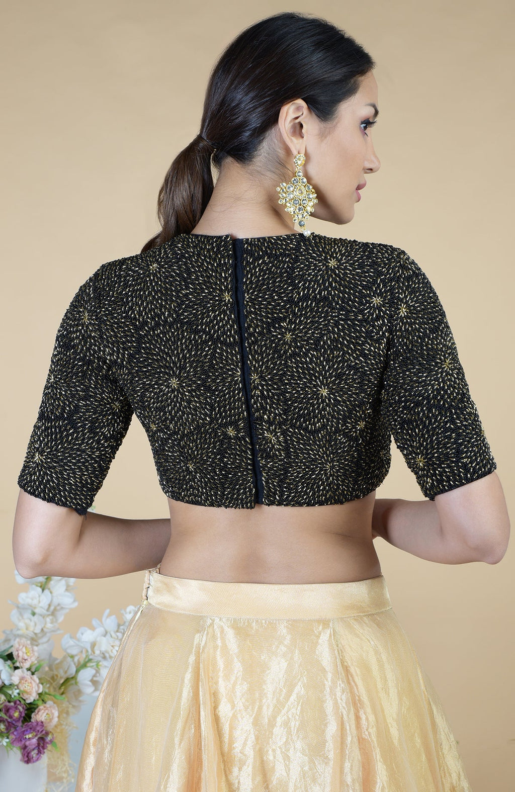Black-gold hand-embroidered blouse with a gold tissue skirt.