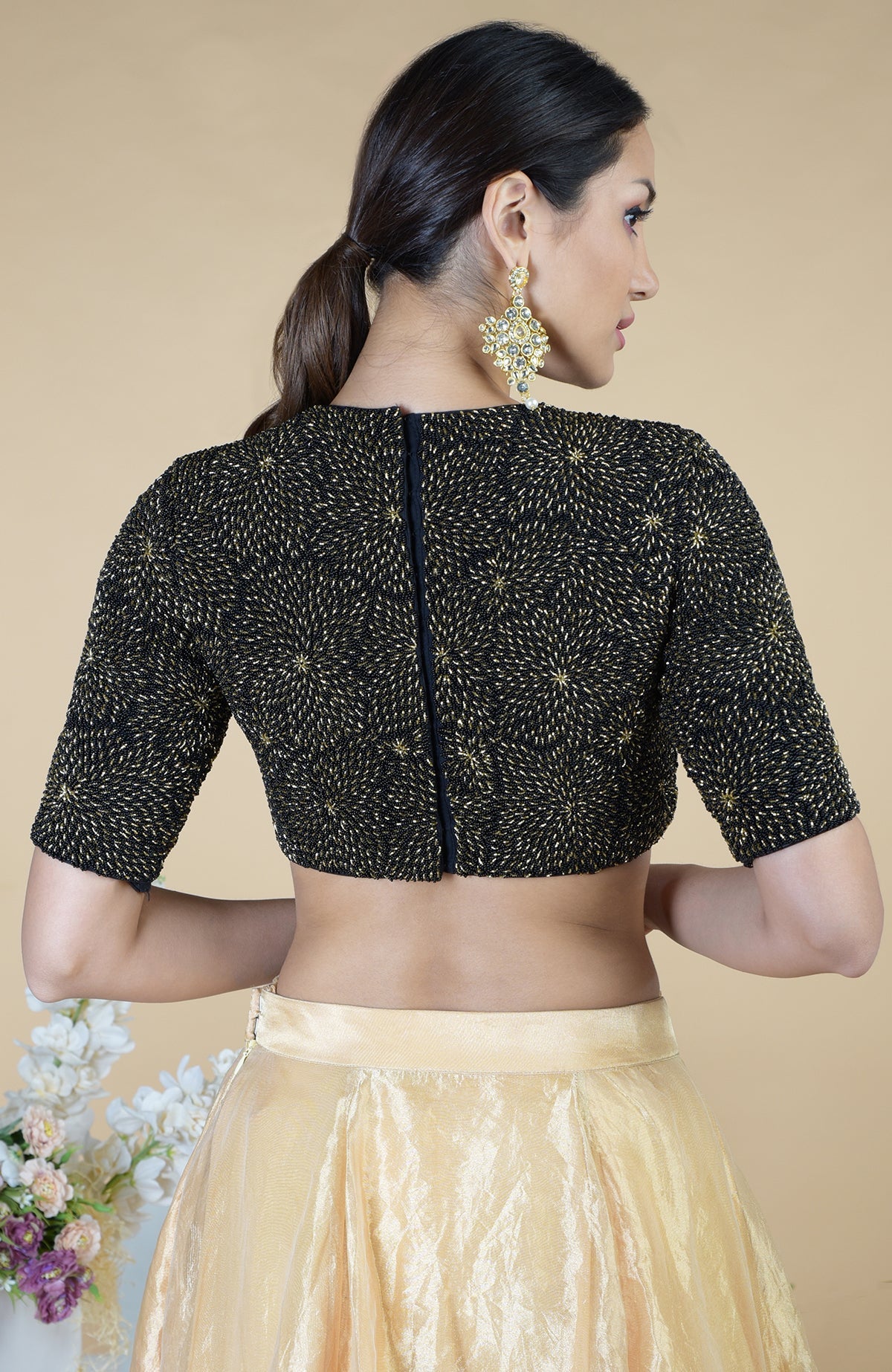 Black-gold hand-embroidered blouse with a gold tissue skirt.