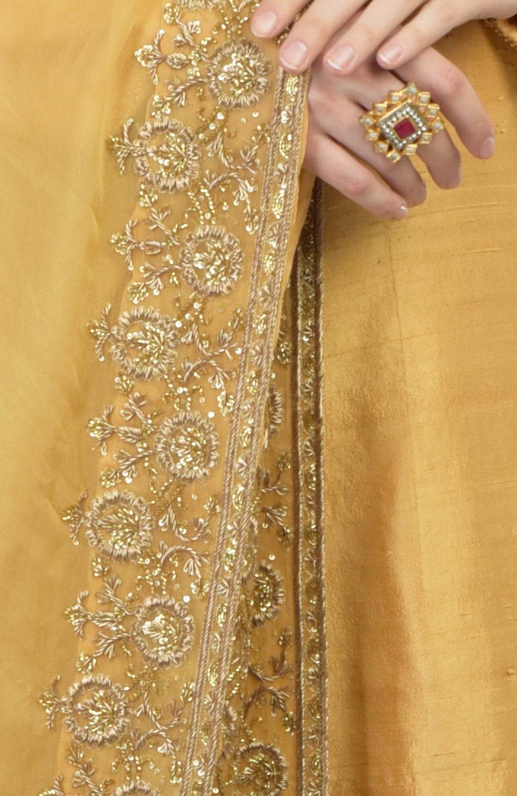 Gold hand-embroidered organza dupatta with a raw silk kurta set, featuring a ring.