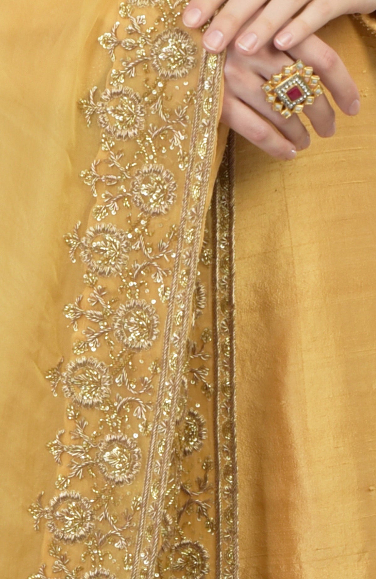 Gold hand-embroidered organza dupatta with a raw silk kurta set, featuring a ring.