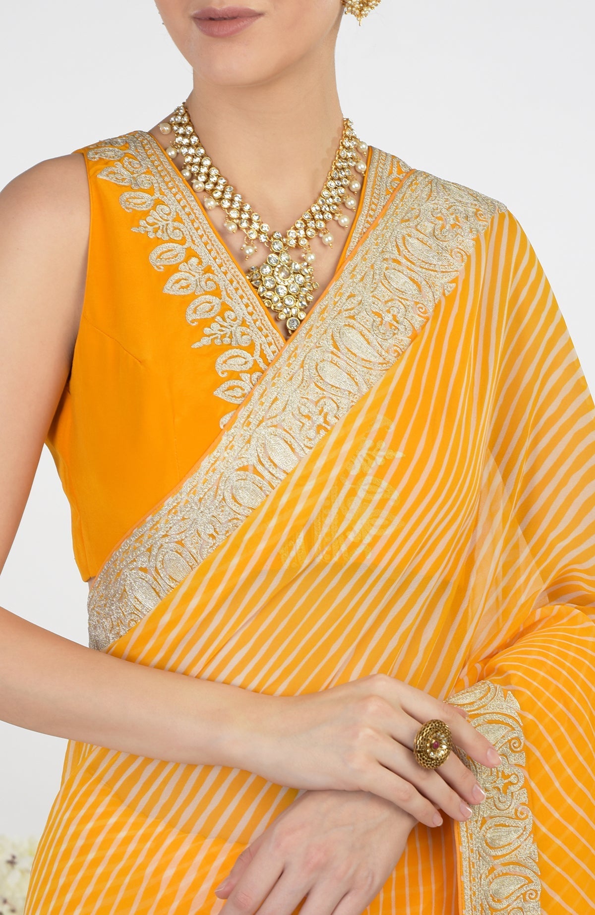 Yellow leheriya saree with Kashmiri paisley tilla aari embroidery and a matching blouse.