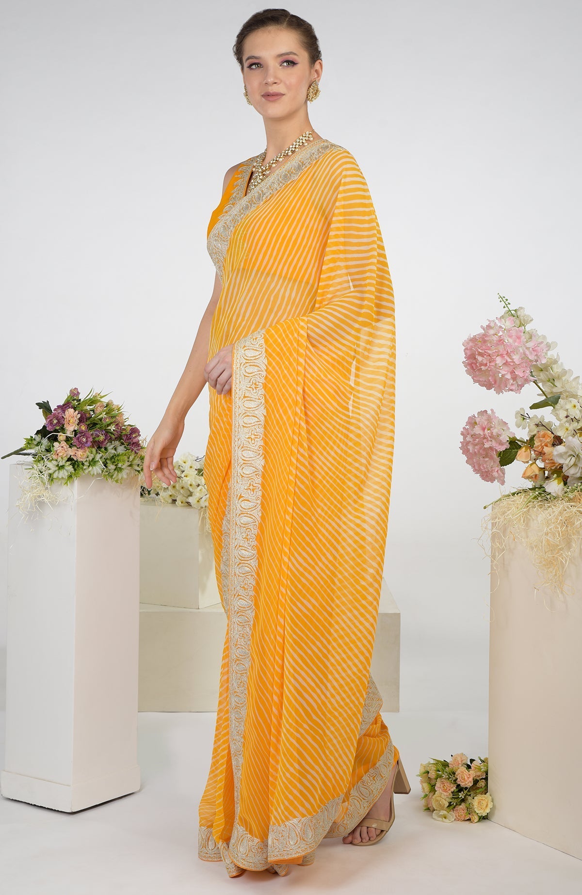 Yellow leheriya saree with Kashmiri paisley tilla aari embroidery.