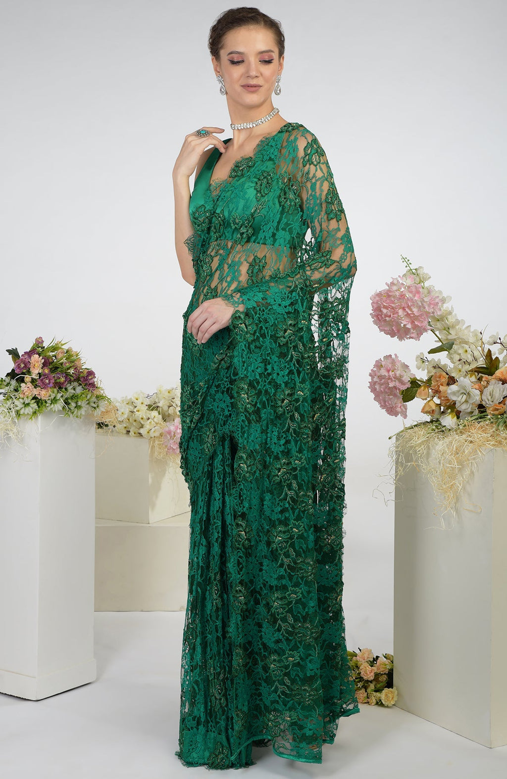 Emerald green French Chantilly hand-embroidered saree with floral motifs.