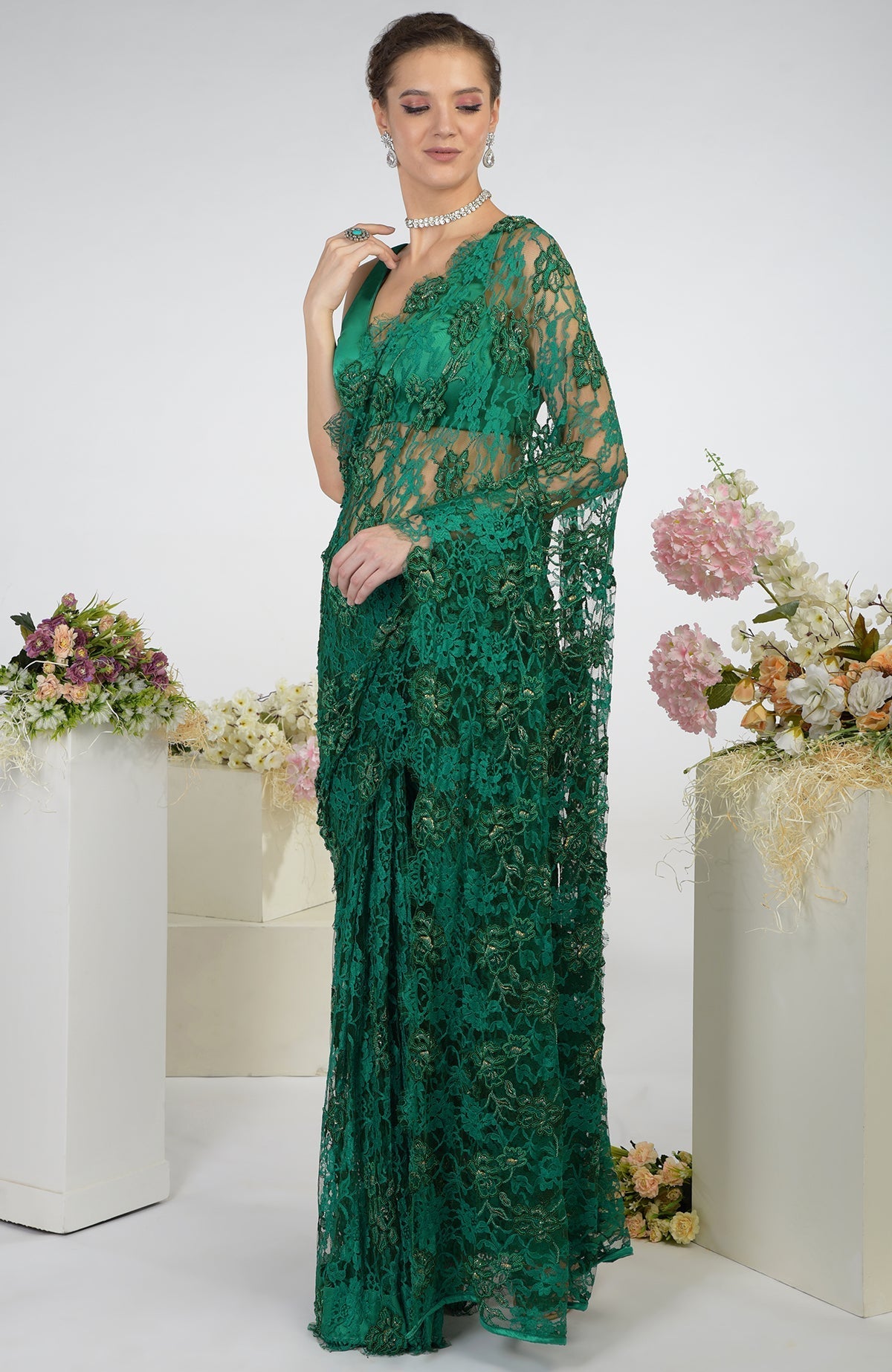 Emerald green French Chantilly hand-embroidered saree with floral motifs.