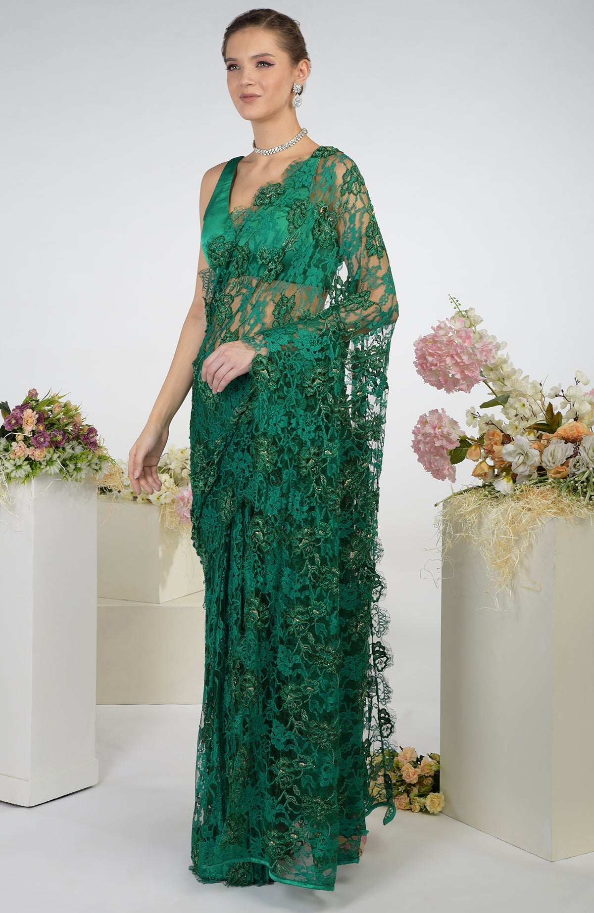 Emerald green French Chantilly hand-embroidered saree with a matching blouse.