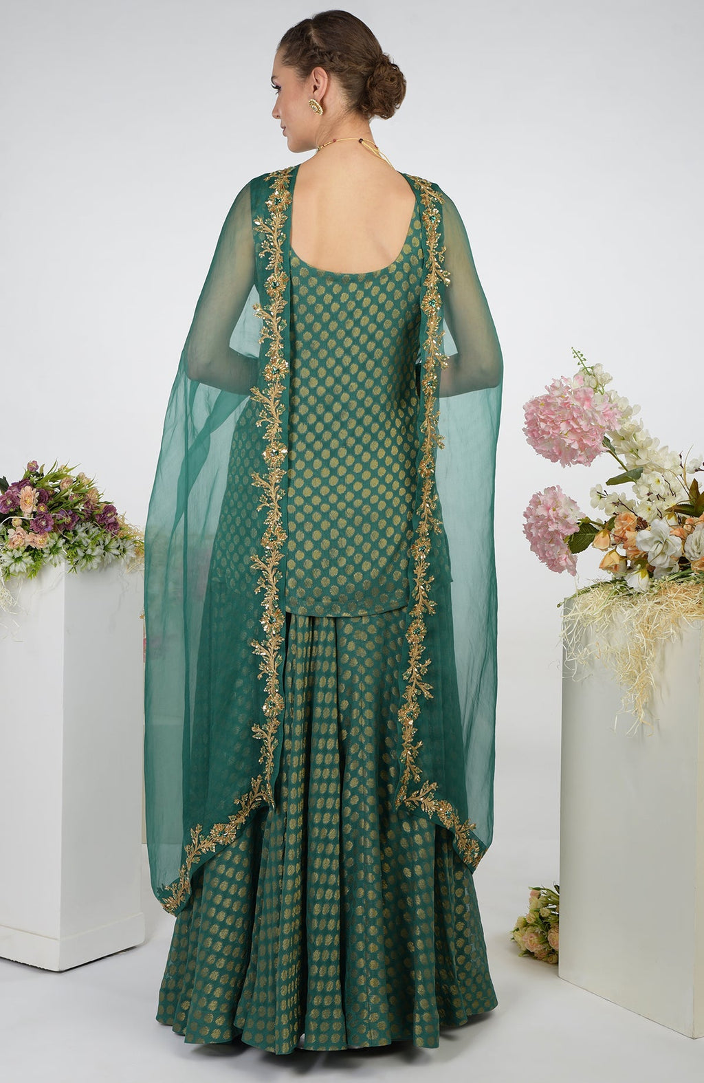 Bottle green Banarasi zardozi kalidaar skirt set with a short tunic and dupatta.