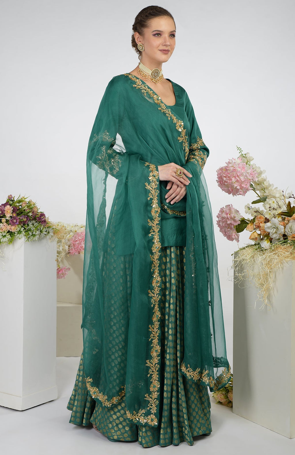 Bottle green Banarasi zardozi kalidaar skirt set with gold embroidery.